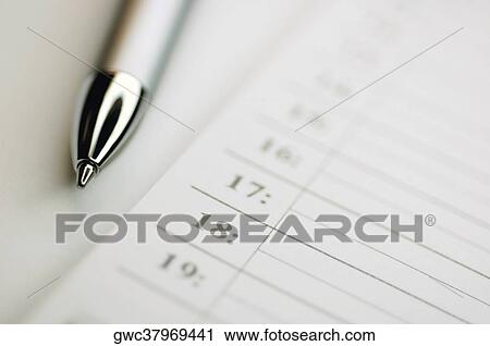 Stock Image - Close-up of a ballpoint pen and paper. Fotosearch