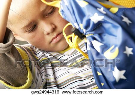 Close-up of a boy holding a bag View Large Photo Image Stock Photograph - Close-up of a boy holding a bag. Fotosearch