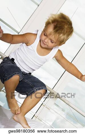 Close-up of a boy jumping on the bed View Large Photo Image Stock Photograph - Close-up of a boy jumping on the bed. Fotosearch