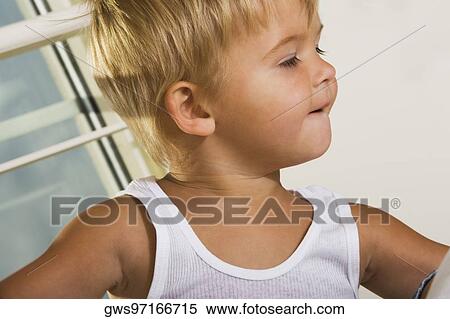 Close-up of a boy looking sideways View Large Photo Image Stock Photography - Close-up of a boy looking sideways. Fotosearch