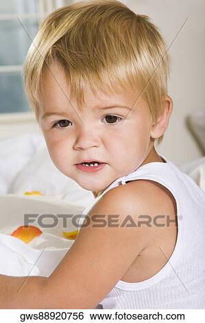 Close-up of a boy lying on the bed View Large Photo Image Stock Photograph - Close-up of a boy lying on the bed. Fotosearch