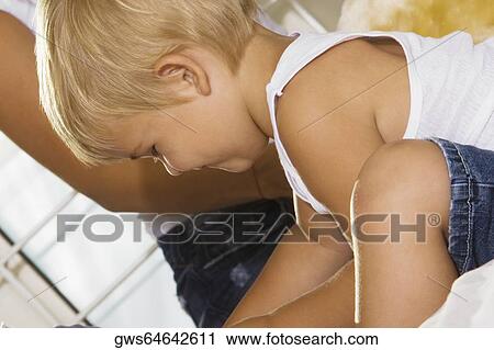 Close-up of a boy playing with his mother View Large Photo Image Stock Image - Close-up of a boy playing with his mother. Fotosearch