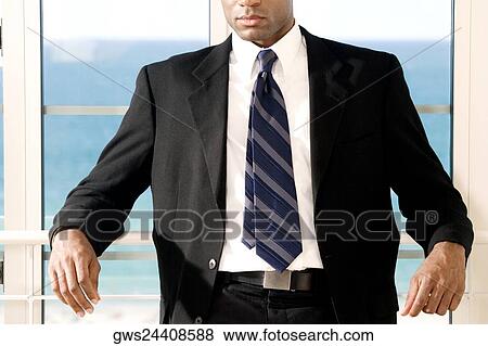 Close-up of a businessman leaning against a railing View Large Photo Image Stock Photo - Close-up of a businessman leaning against a railing. Fotosearch