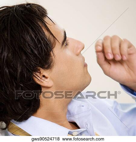 Close-up of a businessman looking away View Large Photo Image Stock Photo - Close-up of a businessman looking away. Fotosearch