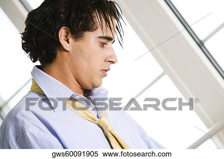 Close-up of a businessman looking down View Large Photo Image Stock Photography - Close-up of a businessman looking down. Fotosearch