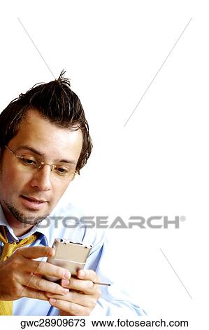 Stock Image - Close-up of a businessman operating a personal data assistant. Fotosearch