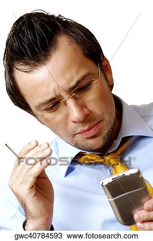 Stock Image - Close-up of a businessman operating a personal data assistant. Fotosearch
