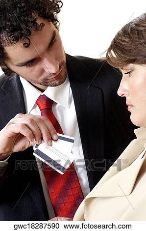 Close-up of a businessman showing credit cards to a businesswoman View Large Photo Image Stock Image - Close-up of a businessman showing credit cards to a businesswoman. Fotosearch