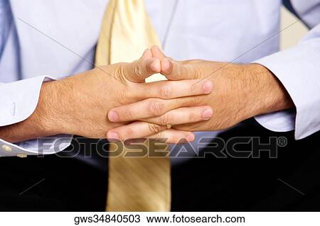 Close-up of a businessman sitting with his hands clasped View Large Photo Image Stock Image - Close-up of a businessman sitting with his hands clasped. Fotosearch