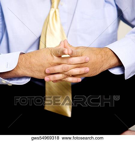 Close-up of a businessman sitting with his hands clasped View Large Photo Image Stock Photo - Close-up of a businessman sitting with his hands clasped. Fotosearch
