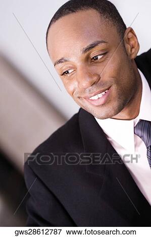 Close-up of a businessman smiling View Large Photo Image Stock Photo - Close-up of a businessman smiling. Fotosearch