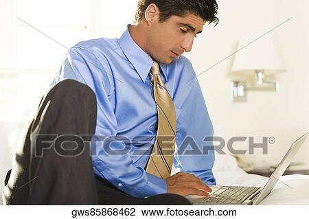 Close-up of a businessman working on a laptop View Large Photo Image Stock Image - Close-up of a businessman working on a laptop. Fotosearch