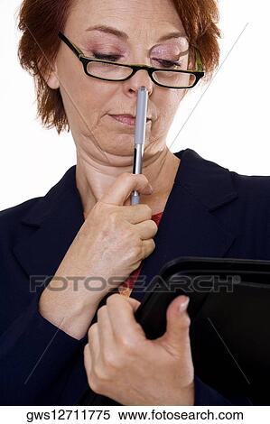 Stock Photography - Close-up of a businesswoman holding a file and a pen. Fotosearch