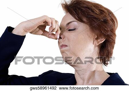 Close-up of a businesswoman holding her nose View Large Photo Image Stock Image - Close-up of a businesswoman holding her nose. Fotosearch