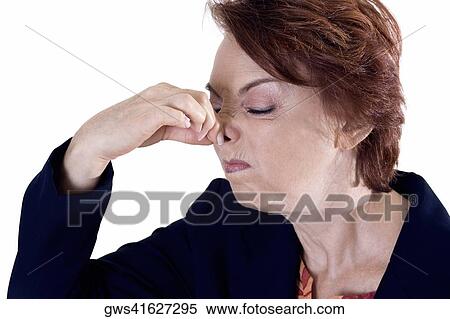 Close-up of a businesswoman holding her nose View Large Photo Image Stock Photography - Close-up of a businesswoman holding her nose. Fotosearch