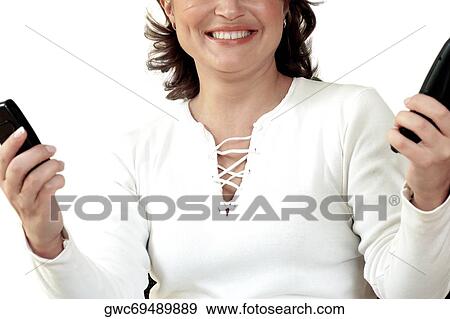 Close-up of a businesswoman holding two mobile phones View Large Photo Image Stock Photo - Close-up of a businesswoman holding two mobile phones. Fotosearch