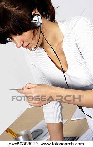 Close-up of a businesswoman looking at a credit card View Large Photo Image Stock Image - Close-up of a businesswoman looking at a credit card. Fotosearch