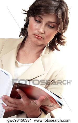 Stock Image - Close-up of a businesswoman reading a magazine. Fotosearch