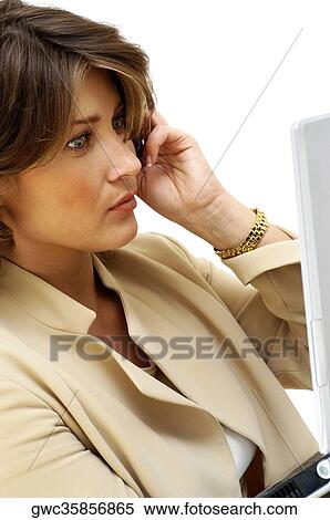 Stock Photography - Close-up of a businesswoman talking on a mobile phone. Fotosearch