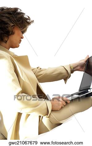 Stock Photo - Close-up of a businesswoman using a laptop. Fotosearch