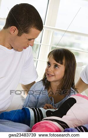 Close-up of a father looking at his daughter View Large Photo Image Stock Photo - Close-up of a father looking at his daughter. Fotosearch