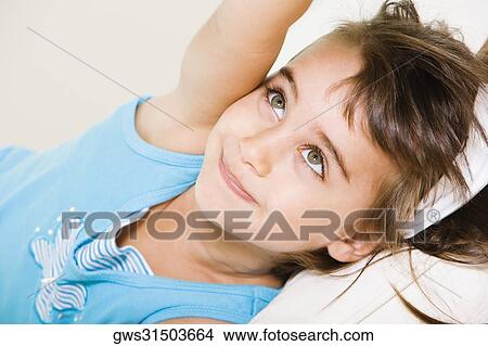 Close-up of a girl lying down View Large Photo Image Picture - Close-up of a girl lying down. Fotosearch