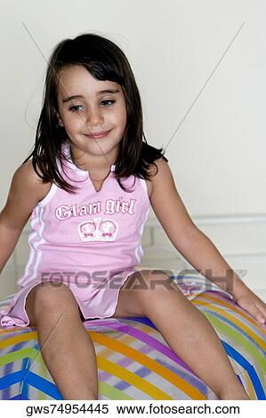 Close-up of a girl sitting on a large inflatable ball View Large Photo Image Stock Photography - Close-up of a girl sitting on a large inflatable ball. Fotosearch
