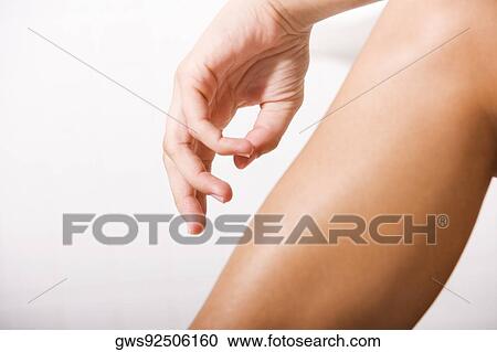 Close-up of a human hand over a human leg View Large Photo Image Stock Image - Close-up of a human hand over a human leg. Fotosearch
