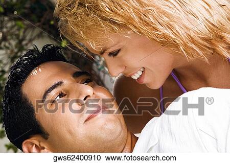 Close-up of a mid adult man and a young woman looking at each other View Large Photo Image Stock Image - Close-up of a mid adult man and a young woman looking at each other. Fotosearch