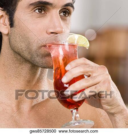 Close-up of a mid adult man drinking a cocktail View Large Photo Image Stock Image - Close-up of a mid adult man drinking a cocktail. Fotosearch