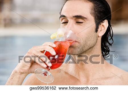 Close-up of a mid adult man drinking a cocktail View Large Photo Image Stock Image - Close-up of a mid adult man drinking a cocktail. Fotosearch