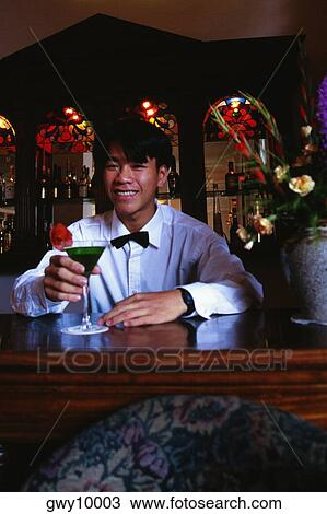 Close-up of a mid adult man holding a cocktail View Large Photo Image Stock Image - Close-up of a mid adult man holding a cocktail. Fotosearch