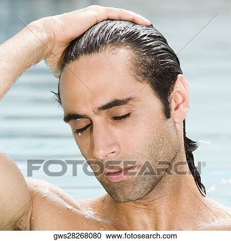 Close-up of a mid adult man in a swimming pool with his eyes closed View Large Photo Image Stock Image - Close-up of a mid adult man in a swimming pool with his eyes closed. Fotosearch
