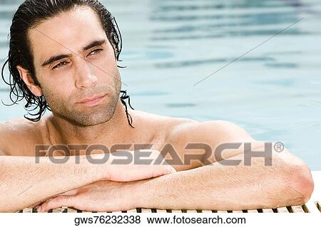 Close-up of a mid adult man leaning at the edge of a swimming pool View Large Photo Image Stock Photo - Close-up of a mid adult man leaning at the edge of a swimming pool. Fotosearch
