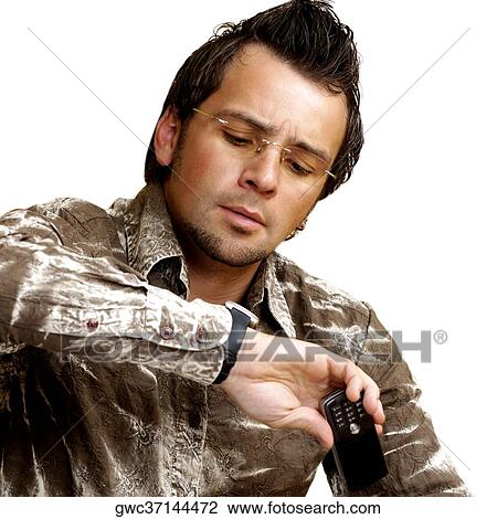 Close-up of a mid adult man looking at his wristwatch View Large Photo Image Stock Image - Close-up of a mid adult man looking at his wristwatch. Fotosearch