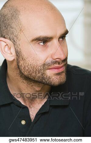 Stock Image - Close-up of a mid adult man looking away. Fotosearch