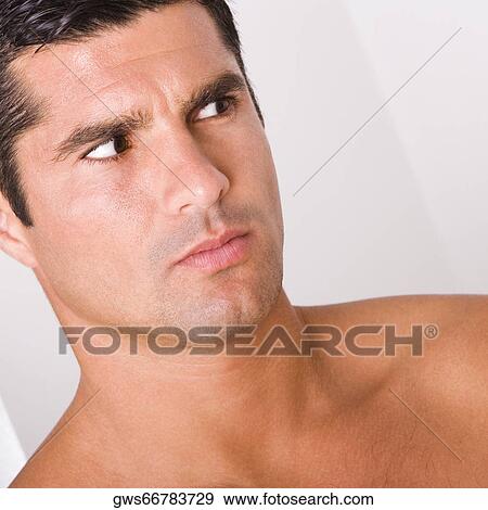 Close-up of a mid adult man looking away View Large Photo Image Stock Photo - Close-up of a mid adult man looking away. Fotosearch