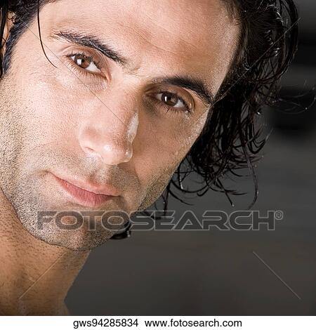 Close-up of a mid adult man looking serious View Large Photo Image Picture - Close-up of a mid adult man looking serious. Fotosearch