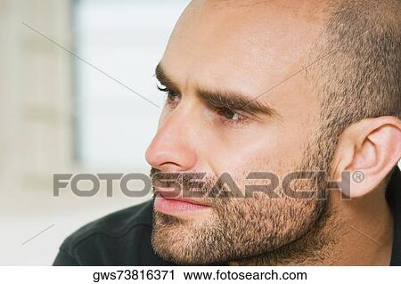 Close-up of a mid adult man looking sideways View Large Photo Image Stock Image - Close-up of a mid adult man looking sideways. Fotosearch