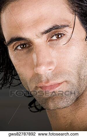 Close-up of a mid adult man looking serious View Large Photo Image Stock Image - Close-up of a mid adult man looking serious. Fotosearch