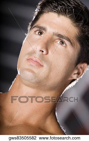 Close-up of a mid adult man looking serious View Large Photo Image Stock Image - Close-up of a mid adult man looking serious. Fotosearch