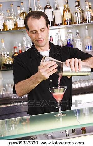 Close-up of a mid adult man preparing a cocktail View Large Photo Image Stock Image - Close-up of a mid adult man preparing a cocktail. Fotosearch