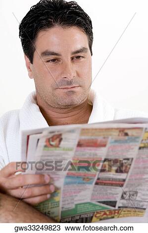 Close-up of a mid adult man reading a newspaper View Large Photo Image Stock Image - Close-up of a mid adult man reading a newspaper. Fotosearch