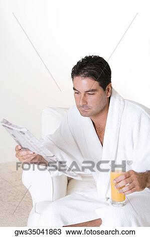 Close-up of a mid adult man reading a newspaper View Large Photo Image Stock Image - Close-up of a mid adult man reading a newspaper. Fotosearch