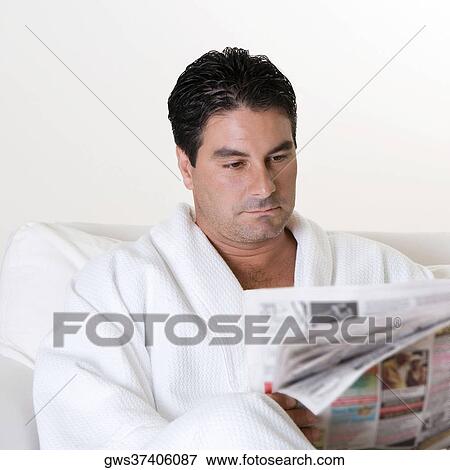Stock Photo - Close-up of a mid adult man reading a newspaper. Fotosearch