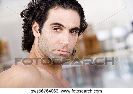 Close-up of a mid adult man sitting near a swimming pool View Large Photo Image Stock Image - Close-up of a mid adult man sitting near a swimming pool. Fotosearch