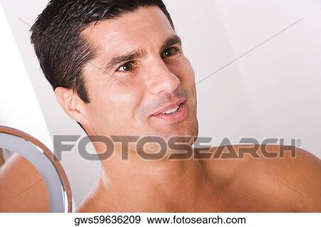 Stock Photo - Close-up of a mid adult man smiling. Fotosearch