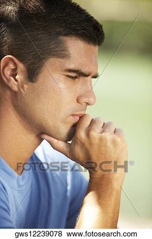 Close-up of a mid adult man thinking View Large Photo Image Stock Photo - Close-up of a mid adult man thinking. Fotosearch