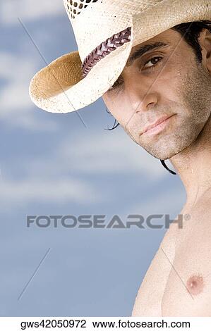 Close-up of a mid adult man wearing a hat View Large Photo Image Stock Image - Close-up of a mid adult man wearing a hat. Fotosearch
