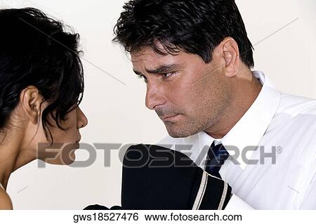 Close-up of a mid adult man wearing boxing gloves staring at a young woman View Large Photo Image Stock Photograph - Close-up of a mid adult man wearing boxing gloves staring at a young woman. Fotosearch